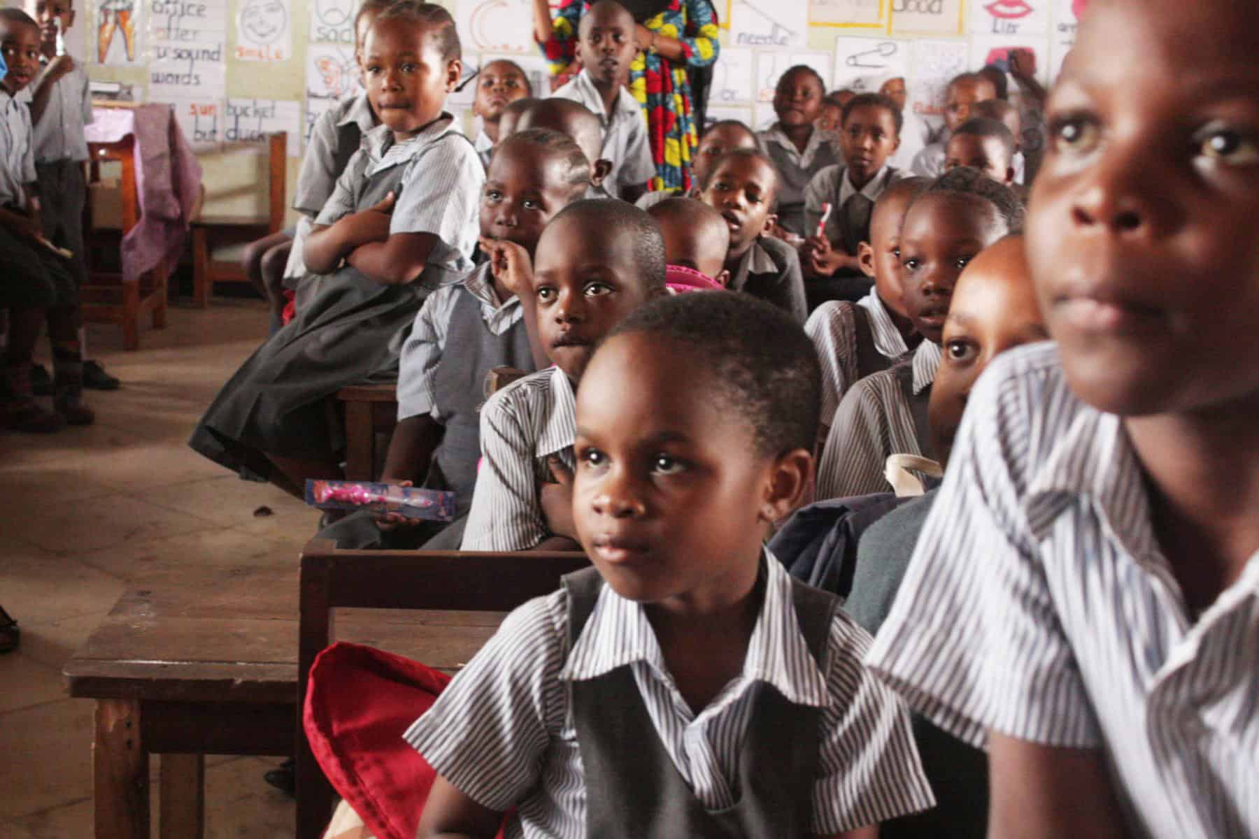 Classroom of young children benefiting from educational initiatives supported by community psychology volunteers and internships in Tanzania.