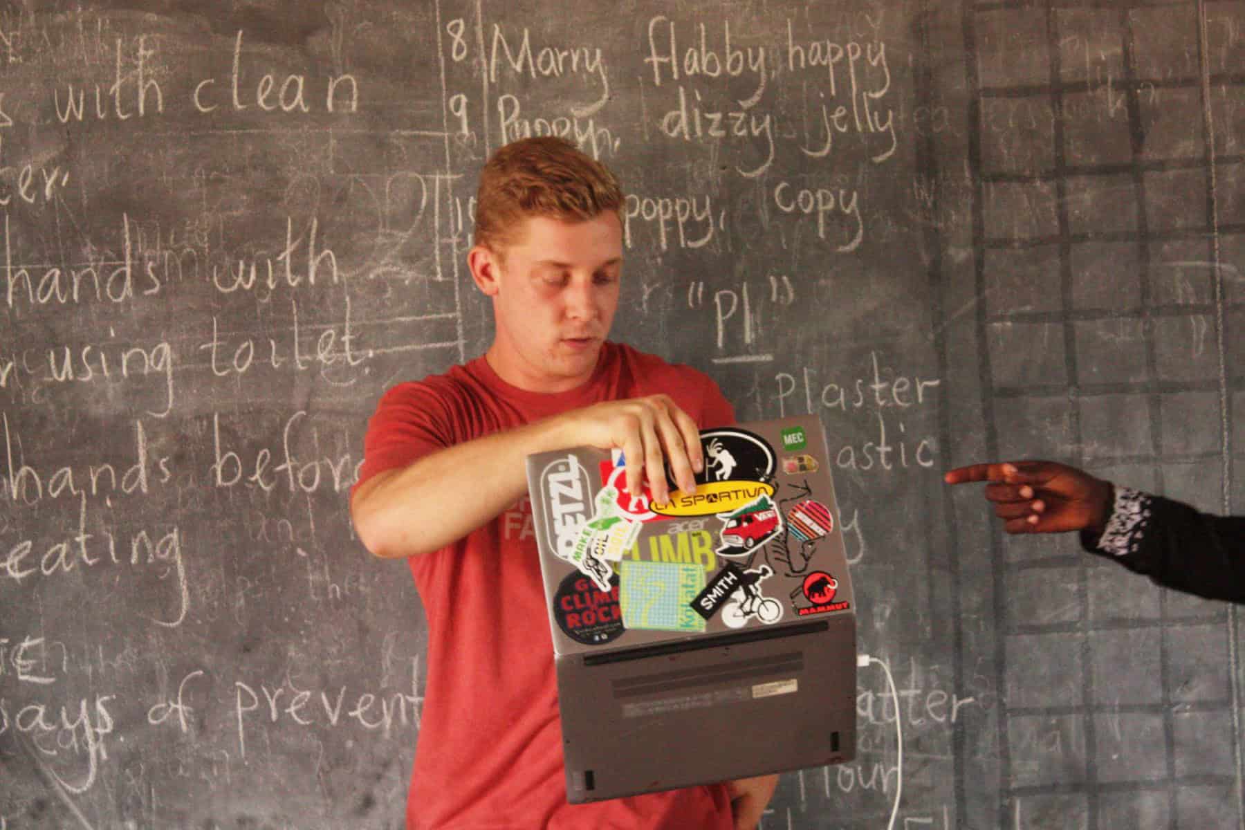 Volunteer leading a business internship in Africa, teaching community members about sustainable business practices in Tanzania.