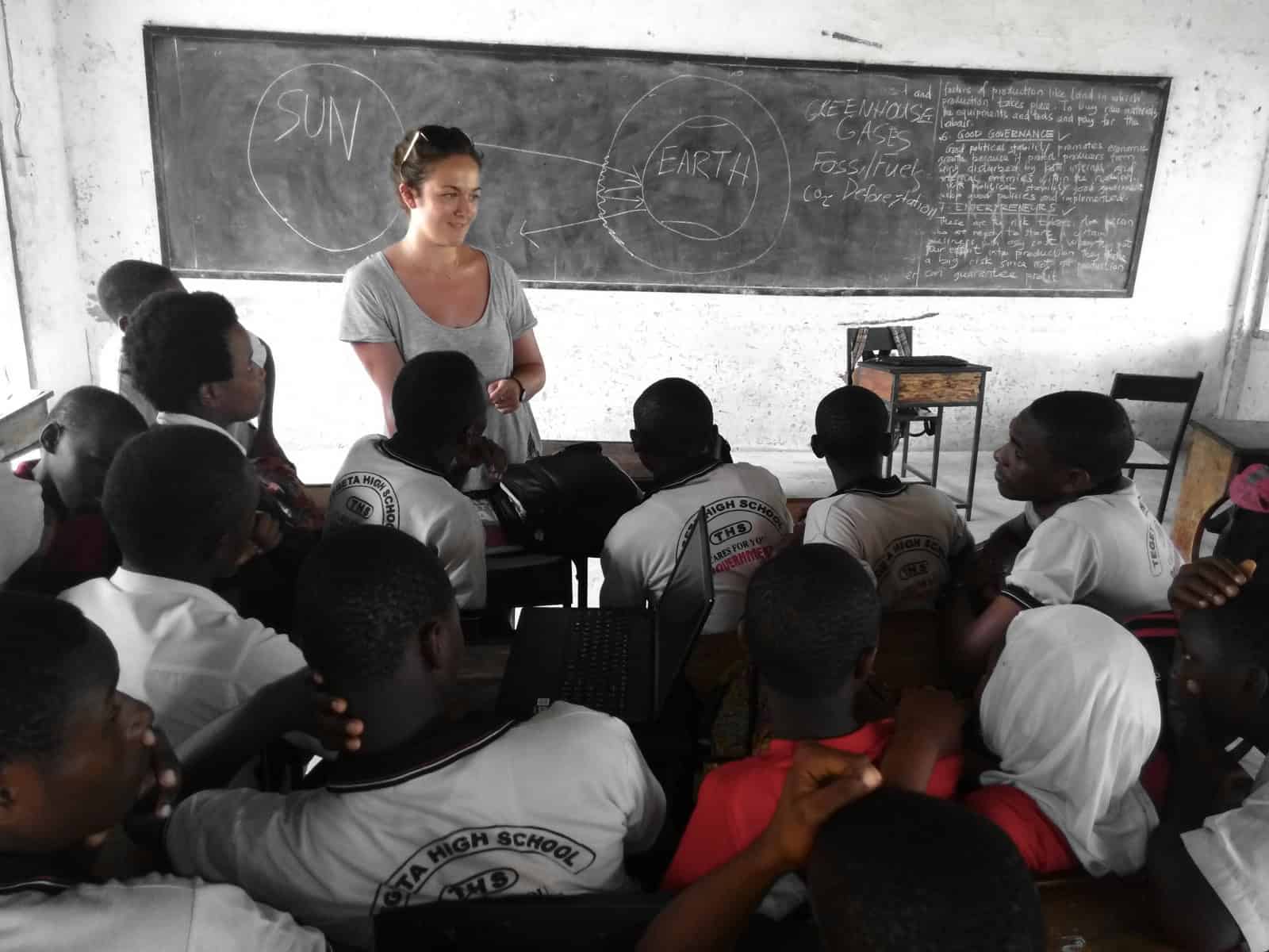 A classroom session with students learning about human rights, facilitated by an international volunteer during an internship program in Tanzania.