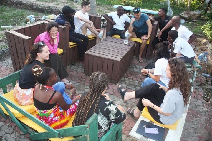 Group of community psychology volunteers discussing programs and initiatives as part of their volunteering and internship experience in Tanzania